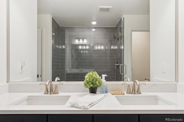 full bath with a shower stall, visible vents, and a sink