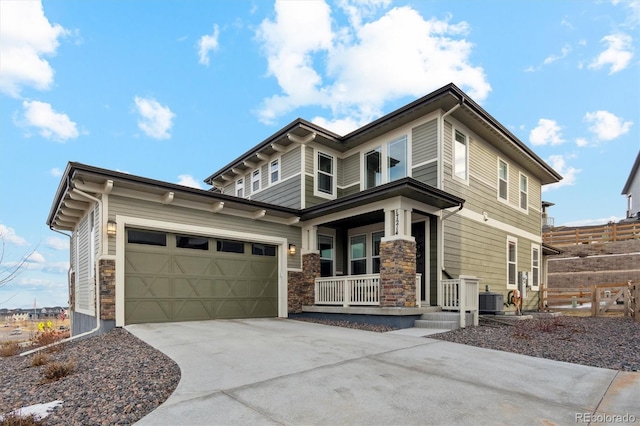 view of front of house featuring driveway, a garage, central AC unit, stone siding, and a porch