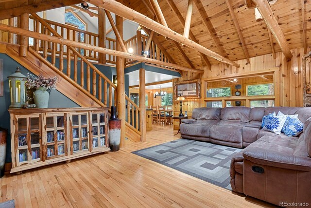8905 Carol Ln, Conifer, CO 80433 - living area with high vaulted ceiling, stairway, hardwood / wood-style floors, a ceiling fan, and wood ceiling with exposed beams