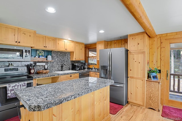 8905 Carol Ln, Conifer, CO 80433 - kitchen with stainless steel appliances, a sink, light brown cabinets, light wood-style floors, and backsplash