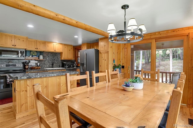 8905 Carol Ln, Conifer, CO 80433 - dining space with a chandelier, light wood-style floors, wooden walls, and recessed lighting