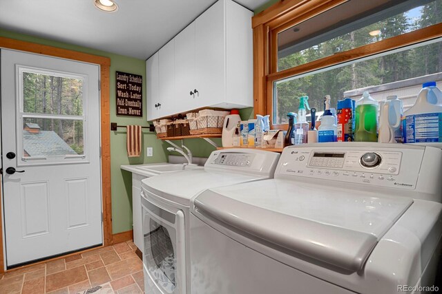 8905 Carol Ln, Conifer, CO 80433 - laundry area with cabinet space, washing machine and dryer, stone finish flooring, and recessed lighting