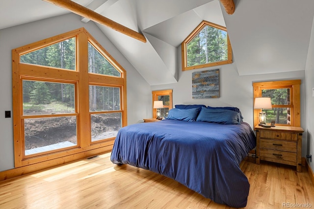 8905 Carol Ln, Conifer, CO 80433 - bedroom featuring wood finished floors, multiple windows, high vaulted ceiling, and beamed ceiling