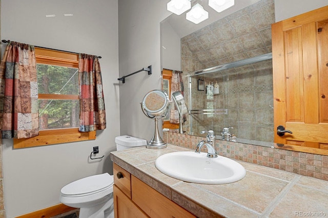 8905 Carol Ln, Conifer, CO 80433 - bathroom with vanity, a stall shower, toilet, and tasteful backsplash