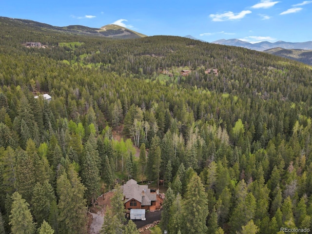 8905 Carol Ln, Conifer, CO 80433 - aerial overview of property's location with a heavily wooded area and a mountain backdrop