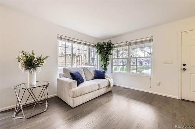 sitting room featuring baseboards and dark wood finished floors
