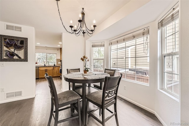 dining area featuring baseboards, a notable chandelier, and visible vents