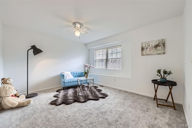 living area featuring carpet floors, a ceiling fan, and baseboards