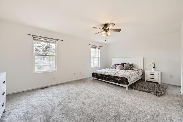 bedroom with a ceiling fan, baseboards, visible vents, and carpet