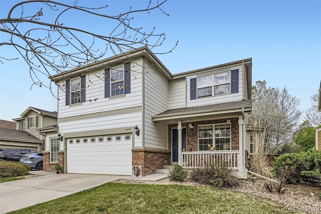 view of front facade featuring covered porch, a front yard, brick siding, concrete driveway, and an attached garage