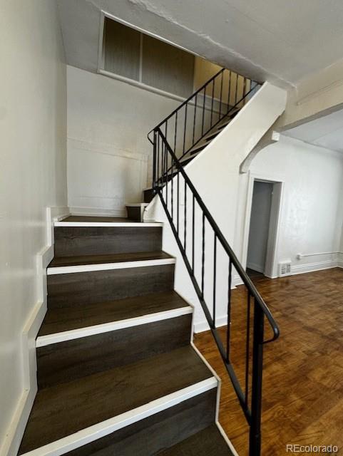 stairway with hardwood / wood-style floors