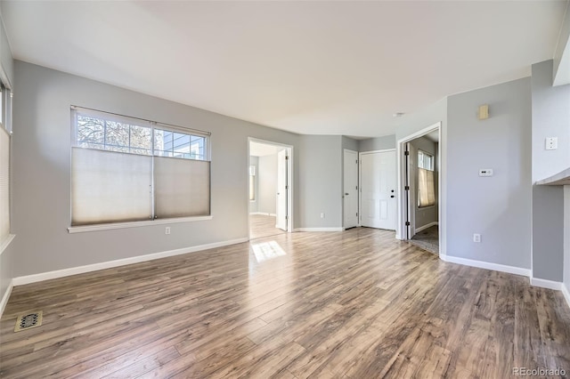 unfurnished living room featuring wood-type flooring