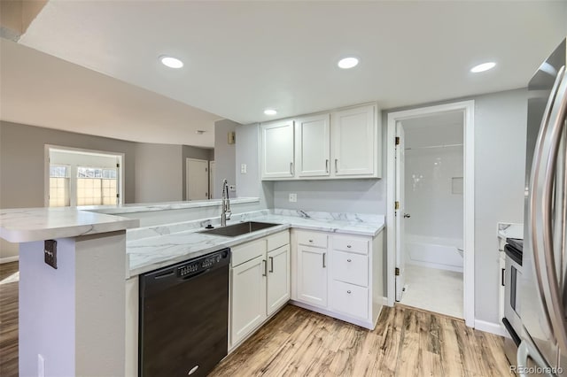 kitchen featuring white cabinetry, sink, stainless steel appliances, and kitchen peninsula