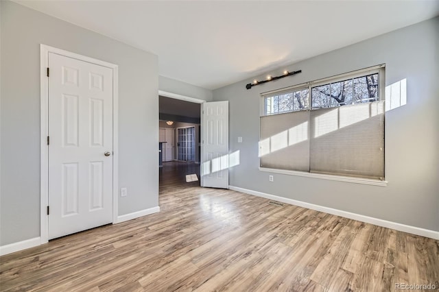 spare room with light hardwood / wood-style floors