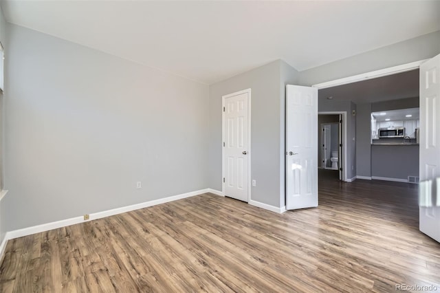 unfurnished room featuring hardwood / wood-style flooring