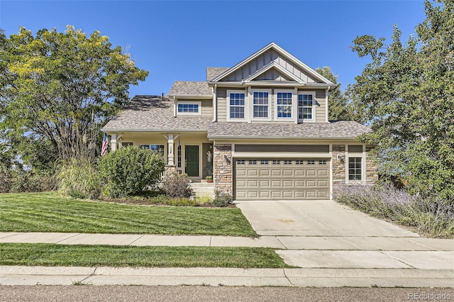 craftsman-style home with a garage, concrete driveway, stone siding, a front lawn, and board and batten siding