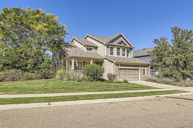 craftsman house with a garage, concrete driveway, stone siding, board and batten siding, and a front yard