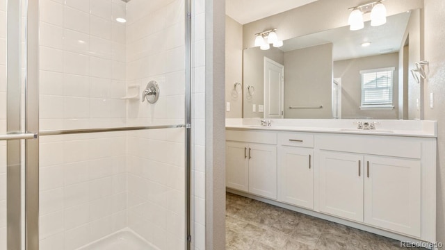 bathroom with an enclosed shower and vanity