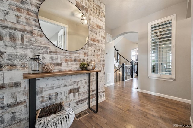 2234 S Nile St, Denver, CO 80228 - hall with arched walkways, wood-type flooring, and stairs