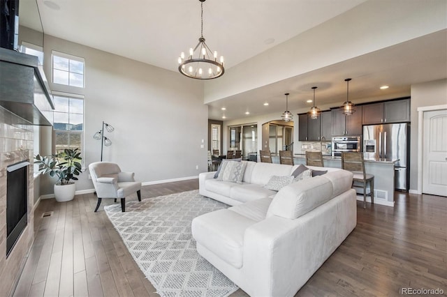 2234 S Nile St, Denver, CO 80228 - living area with a chandelier, dark wood finished floors, recessed lighting, a high end fireplace, and a high ceiling