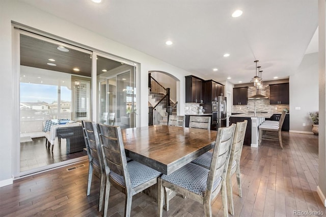 2234 S Nile St, Denver, CO 80228 - dining space with dark wood-style flooring, recessed lighting, stairs, and arched walkways