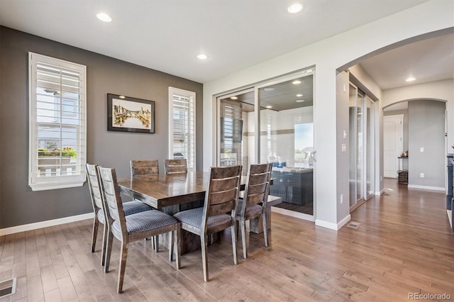 2234 S Nile St, Denver, CO 80228 - dining room with arched walkways, light wood finished floors, and recessed lighting