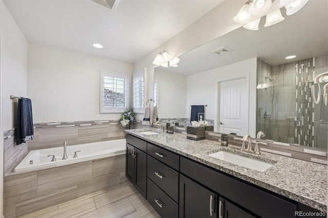 2234 S Nile St, Denver, CO 80228 - bathroom featuring double vanity, a garden tub, a shower stall, and recessed lighting