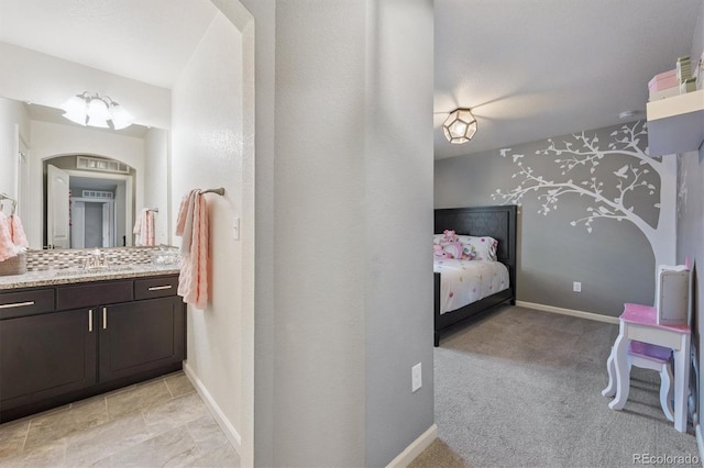 2234 S Nile St, Denver, CO 80228 - ensuite bathroom featuring vanity and baseboards