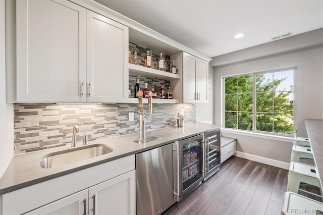 2234 S Nile St, Denver, CO 80228 - indoor wet bar featuring wine cooler, fridge, dark wood-type flooring, decorative backsplash, and recessed lighting