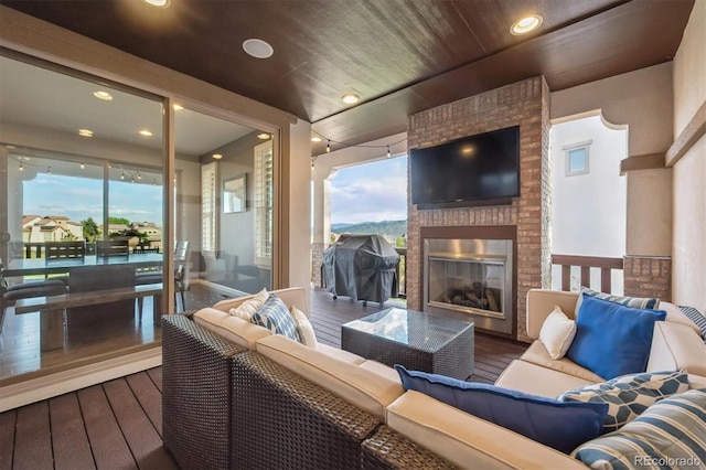 2234 S Nile St, Denver, CO 80228 - wooden deck with a grill and an outdoor living space with a fireplace