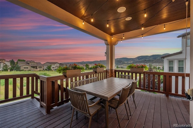 2234 S Nile St, Denver, CO 80228 - deck at dusk featuring a mountain view and outdoor dining space