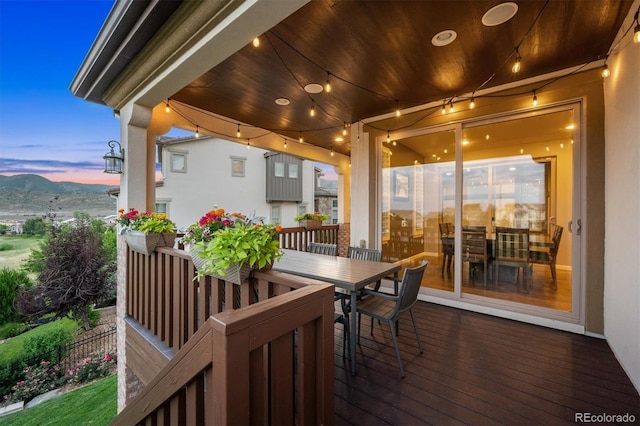 2234 S Nile St, Denver, CO 80228 - deck at dusk featuring outdoor dining space and a mountain view