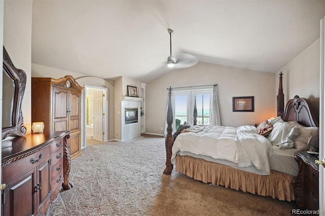 10520 W Vassar Dr, Lakewood, CO 80227 - bedroom with lofted ceiling, light colored carpet, a glass covered fireplace, ensuite bathroom, and baseboards