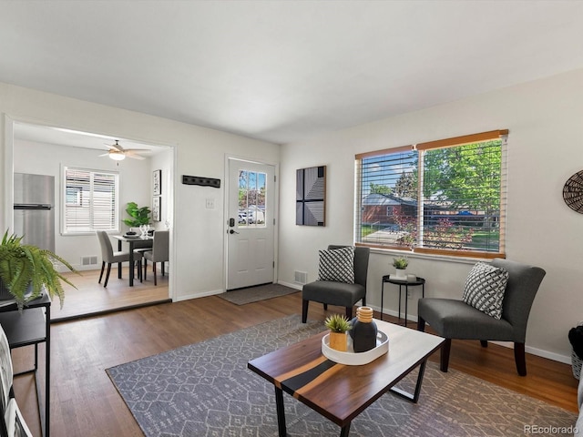 4740 W Wyoming Pl, Denver, CO 80219 - living room featuring plenty of natural light, wood finished floors, and ceiling fan