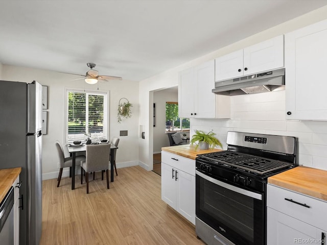 4740 W Wyoming Pl, Denver, CO 80219 - kitchen featuring stainless steel appliances, wooden counters, under cabinet range hood, ceiling fan, and healthy amount of natural light