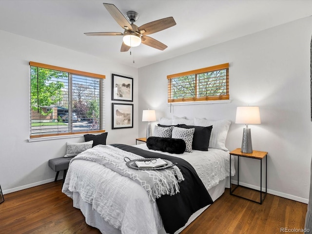 4740 W Wyoming Pl, Denver, CO 80219 - bedroom with multiple windows, baseboards, and wood finished floors
