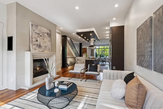 370 Garfield St, Denver, CO 80206 - living area featuring wood finished floors, a lit fireplace, stairway, and recessed lighting
