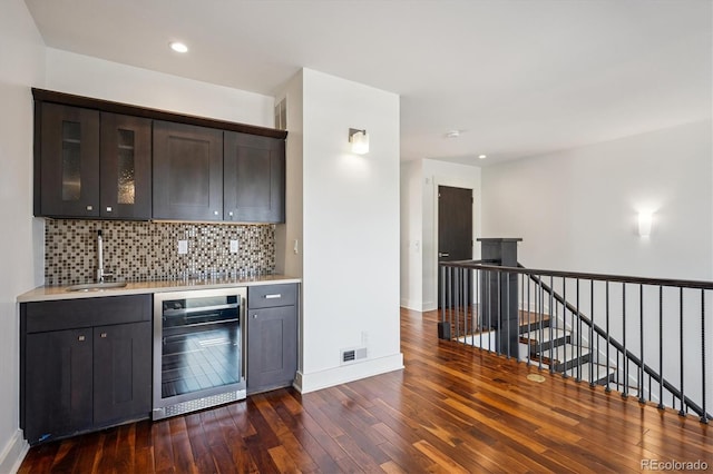 370 Garfield St, Denver, CO 80206 - kitchen featuring wine cooler, dark wood finished floors, light countertops, tasteful backsplash, and recessed lighting