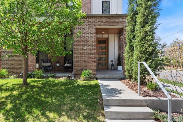 501 S Race St, Denver, CO 80209 - view of exterior entry featuring brick siding, a yard, and a porch