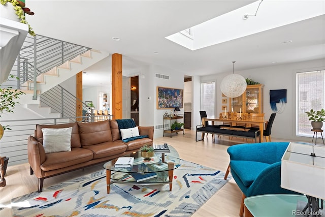 501 S Race St, Denver, CO 80209 - living area featuring healthy amount of natural light, wood finished floors, stairs, a skylight, and recessed lighting