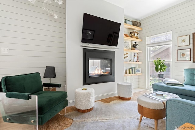 501 S Race St, Denver, CO 80209 - living room featuring wood walls, wood finished floors, and a multi sided fireplace