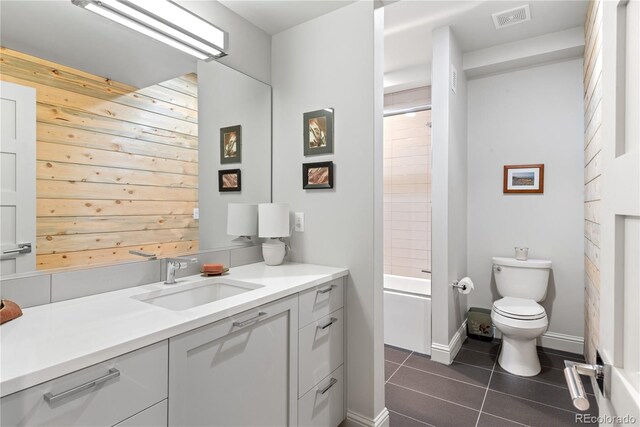 501 S Race St, Denver, CO 80209 - full bath featuring tile patterned flooring, vanity, toilet, and wooden walls