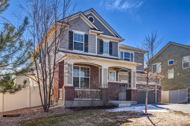 view of front of home with brick siding, fence, a porch, driveway, and an attached garage