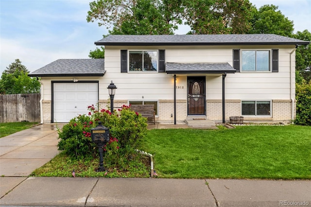 7912 Fenton St, Arvada, CO 80003 - view of front facade with brick siding, concrete driveway, a garage, and a shingled roof