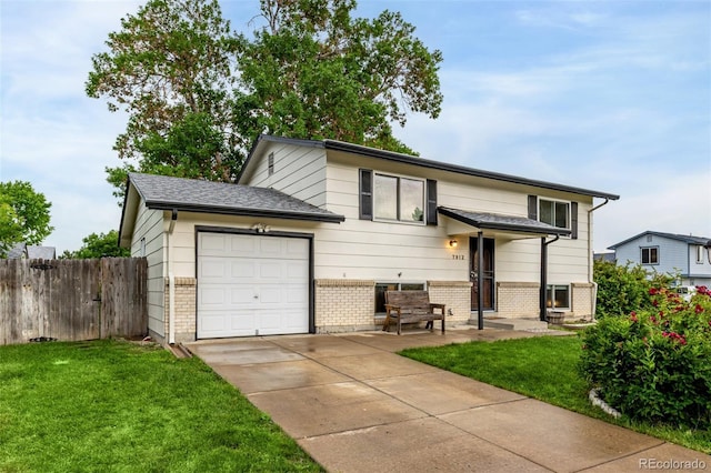 7912 Fenton St, Arvada, CO 80003 - view of front of home featuring brick siding, a garage, and driveway