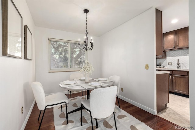 7912 Fenton St, Arvada, CO 80003 - dining room featuring a chandelier and light wood-style flooring