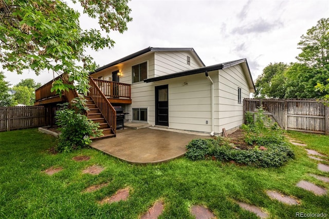 7912 Fenton St, Arvada, CO 80003 - back of property with stairway, a fenced backyard, a patio, and a deck