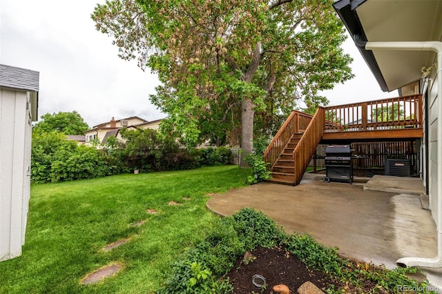 7912 Fenton St, Arvada, CO 80003 - view of grassy yard featuring a patio area, stairs, and a deck