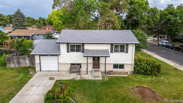 7912 Fenton St, Arvada, CO 80003 - bi-level home with brick siding, driveway, roof with shingles, and a garage
