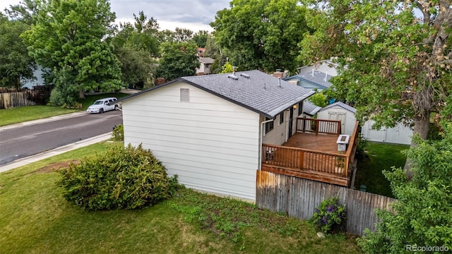7912 Fenton St, Arvada, CO 80003 - view of side of home featuring a deck, a shed, and a shingled roof